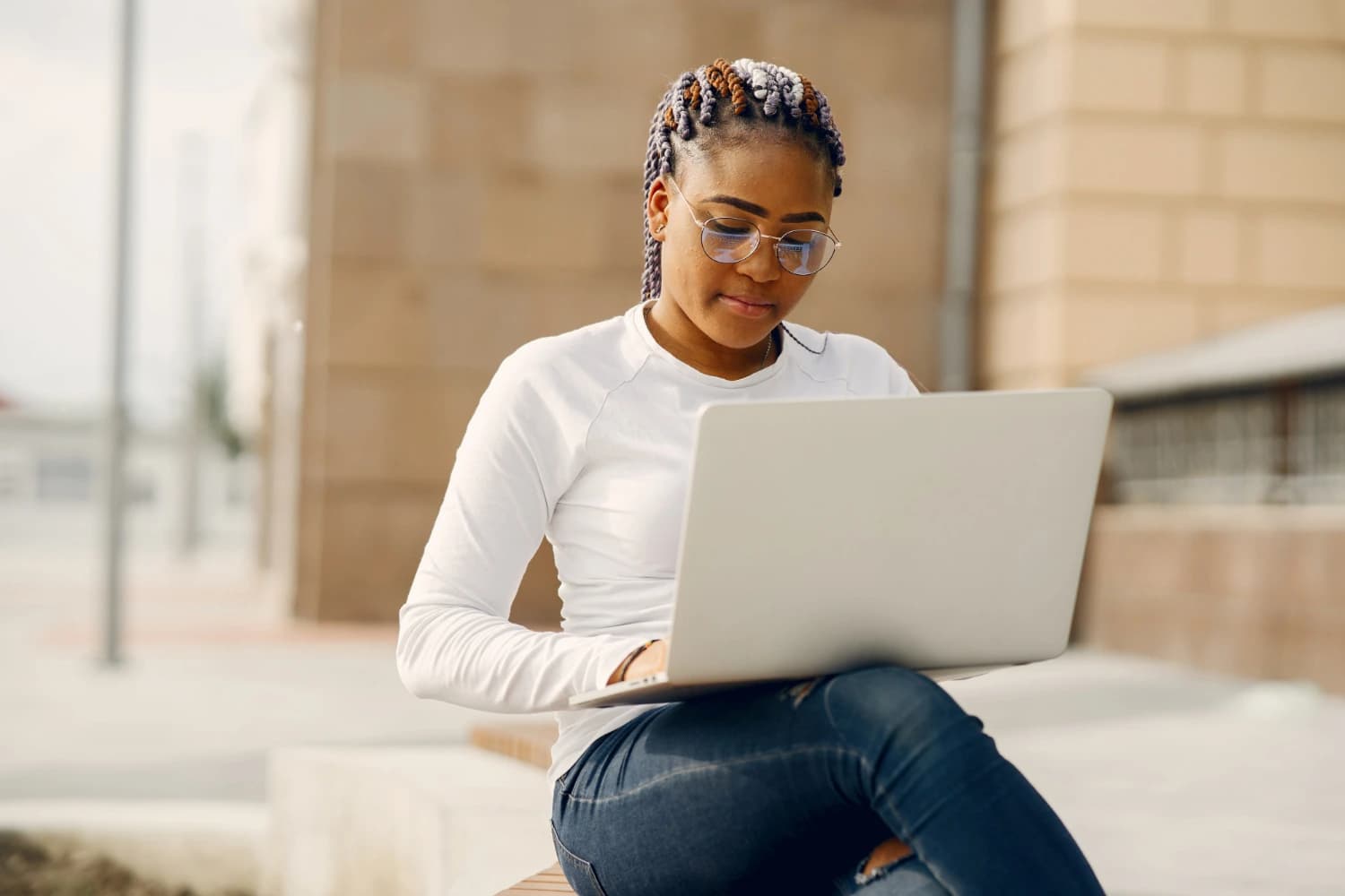 An image of a black young girl with curly hair in front of a computer